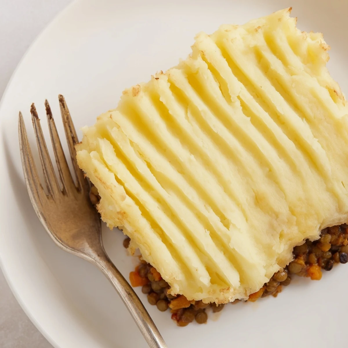 Imagine a close-up of Hearty Lentil Shepherd's Pie: steaming and delicious, a dinner staple.