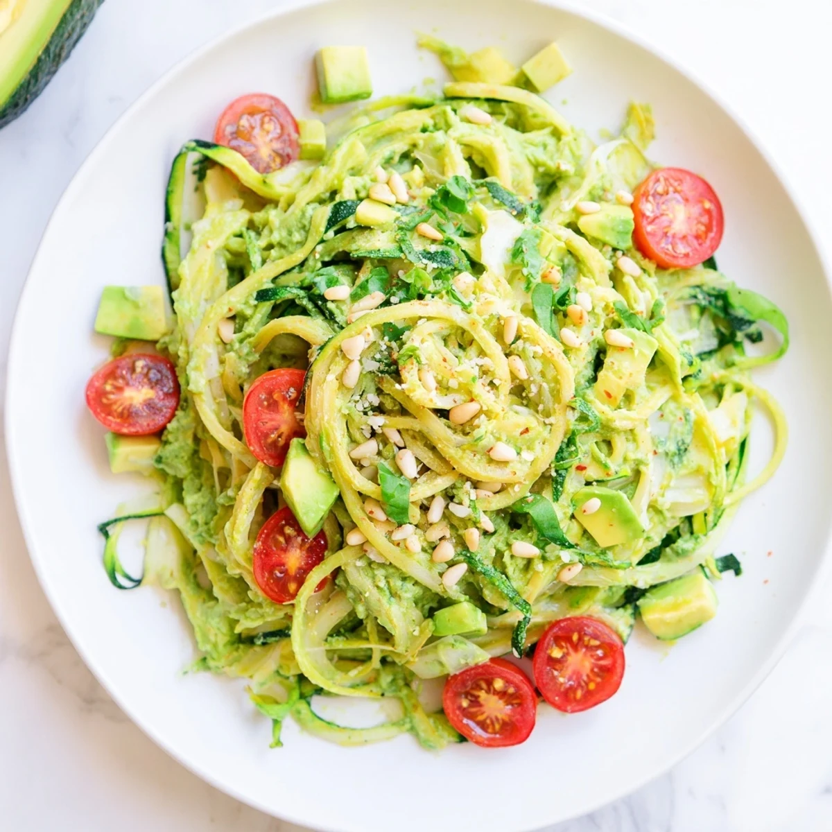 A bowl of fresh Green Goddess Zoodle Pasta, featuring spiralized zucchini and a tangy herb sauce, perfect meal.