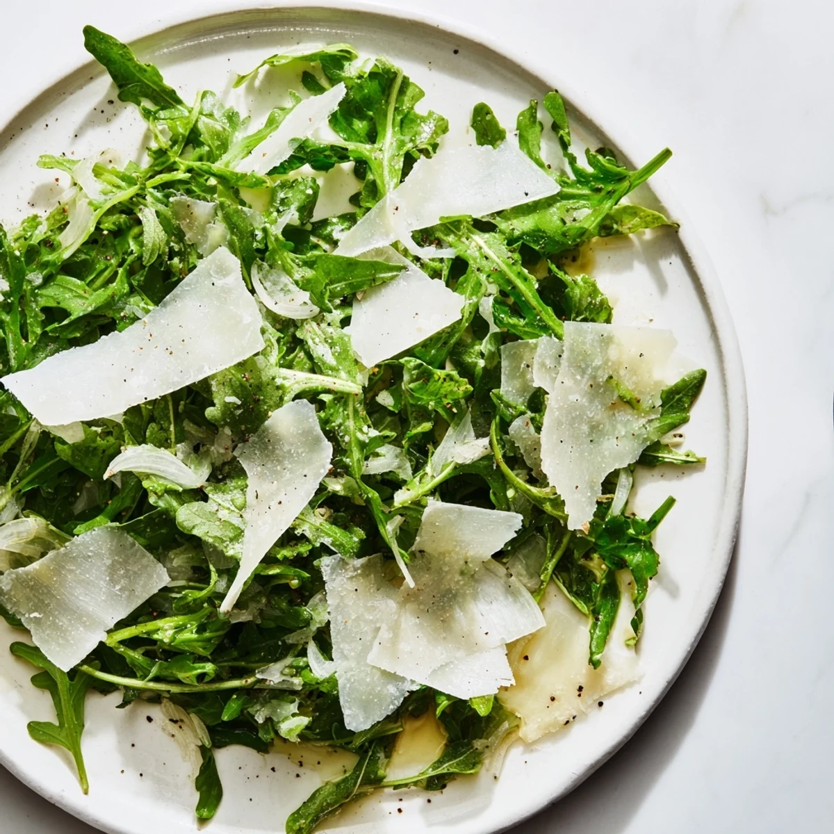 This appetizing arugula salad features a zesty lemon dressing, creating a refreshing Italian-inspired meal.