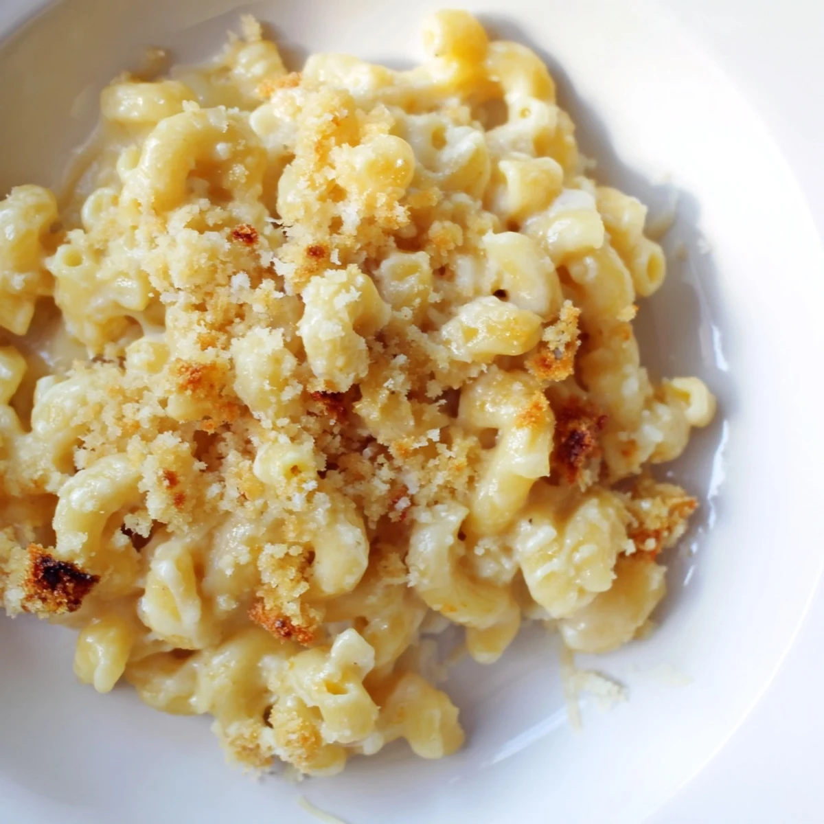 A close-up of cheesy mac and cheese, perfectly cooked, rich with melted cheese and flavors.