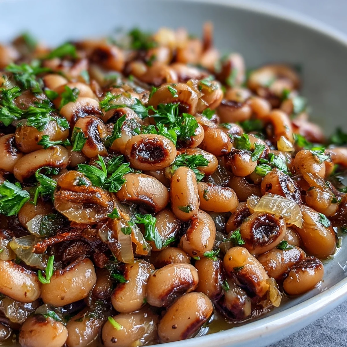 Steaming bowl of Southern-style Frozen Black-Eyed Peas Quick Version topped with fresh parsley, served beside golden cornbread for dinner.