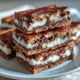 1. Indulge in rich clotted cream cookie bars with white chocolate, featuring buttery layers and creamy chocolate chunks for a decadent treat.  