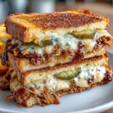 Juicy BBQ pulled pork grilled cheese sandwich, perfectly grilled on sourdough.