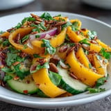 Freshly prepared Mango Cucumber Tajín Ribbon Salad, a colorful summer side dish.