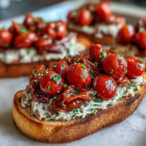 Toasted rustic bread piled high with warm, tender tomato sardine mixture.