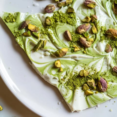 Creamy white chocolate Pistachio Matcha bark with vibrant green matcha swirls and crunchy pistachios.