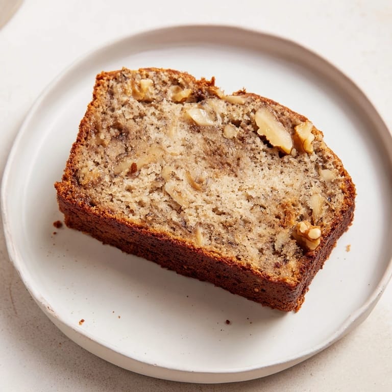 A warm, moist slice of homemade Simple Banana Bread, perfect for morning coffee or afternoon tea.