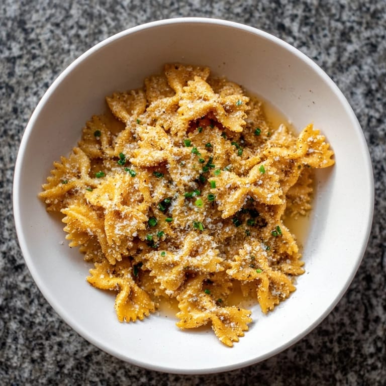Savory pasta chip cereal served with rich parmesan broth, offering a unique and delicious snack option.