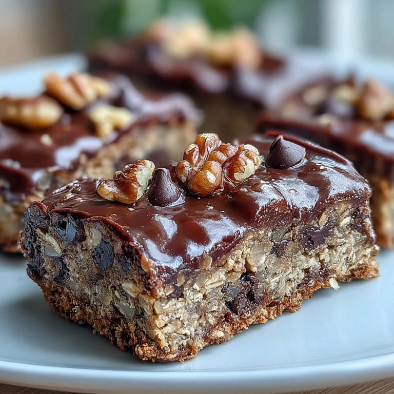 Close-up of one soft Chunky Monkey Protein Baked Oat Bar with melted chocolate and coconut.