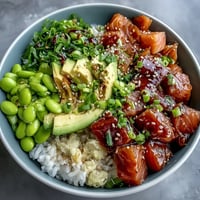 Vibrant Salmon Poke Bowl with creamy avocado and edamame, a healthy lunch.