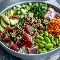 Fresh canned tuna poke bowl with vibrant veggies and zesty dressing, ready in minutes.
